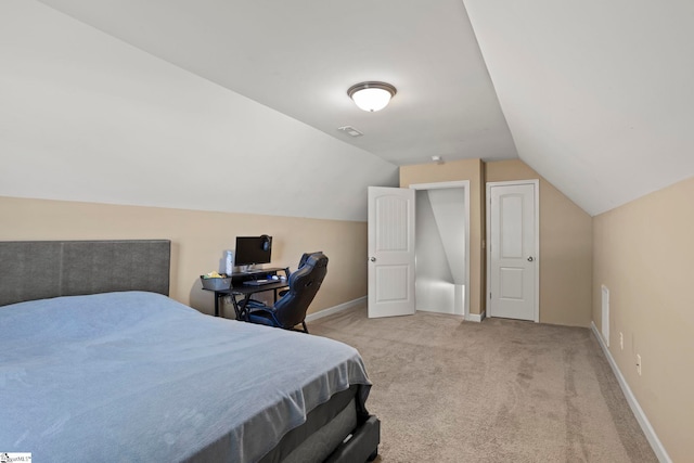 carpeted bedroom with vaulted ceiling