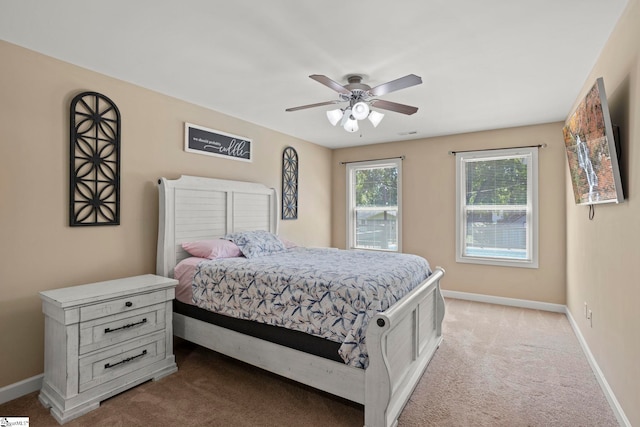 bedroom with light colored carpet and ceiling fan