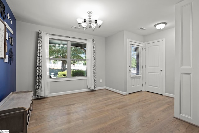 foyer featuring an inviting chandelier and light hardwood / wood-style floors