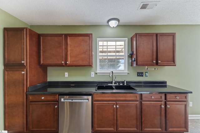 kitchen with stainless steel dishwasher, sink, and a textured ceiling