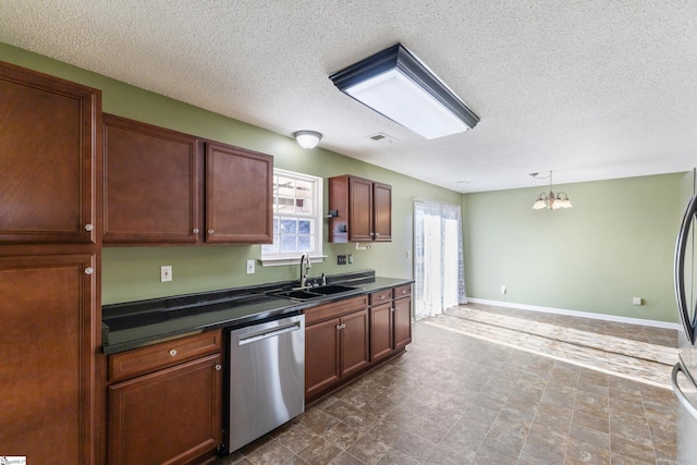 kitchen with an inviting chandelier, sink, hanging light fixtures, stainless steel dishwasher, and a textured ceiling