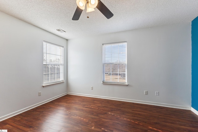 spare room with dark hardwood / wood-style flooring, ceiling fan, and a textured ceiling