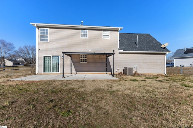 rear view of house with a patio area, central air condition unit, and a lawn