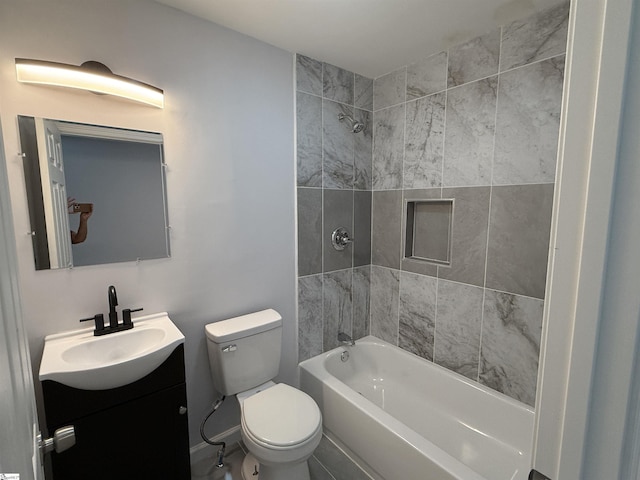 full bathroom featuring vanity, toilet, and tiled shower / bath