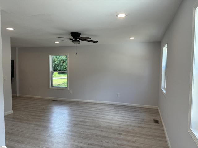 spare room featuring ceiling fan and light hardwood / wood-style flooring