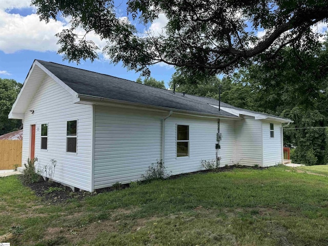 view of side of property with a yard