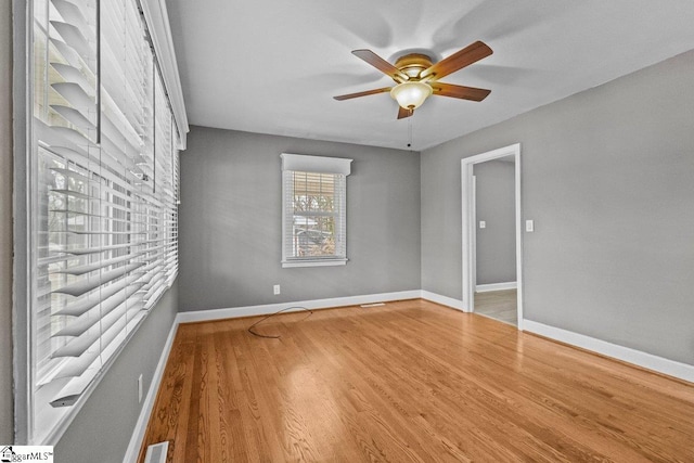 unfurnished room featuring ceiling fan and hardwood / wood-style floors