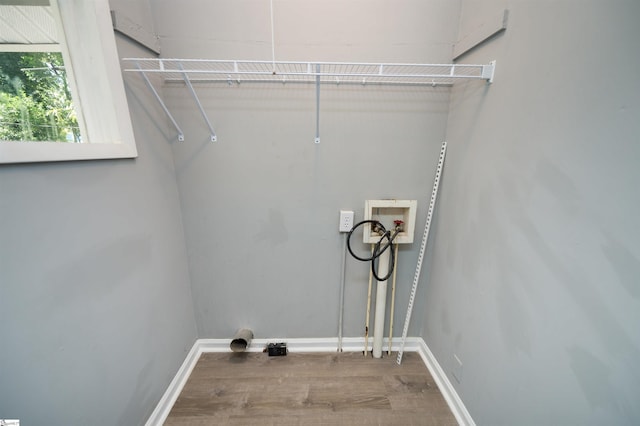 clothes washing area featuring wood-type flooring and hookup for a washing machine