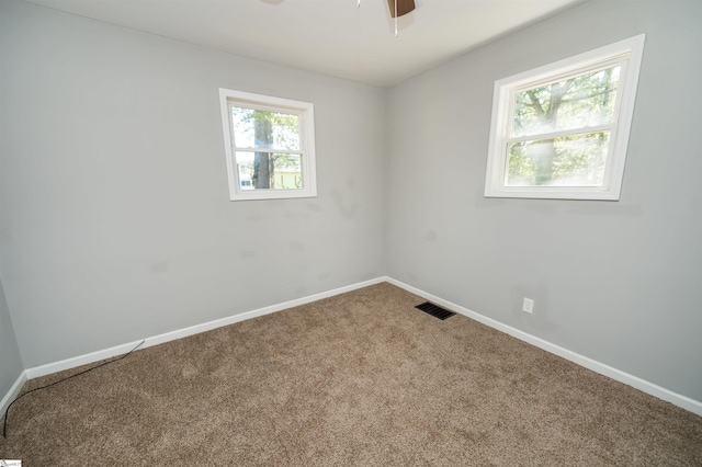 carpeted empty room with ceiling fan