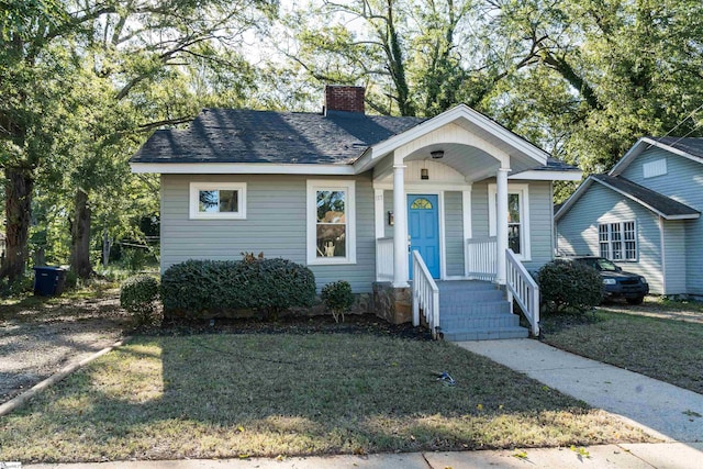 bungalow-style home with a front yard