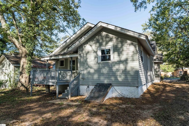 rear view of house featuring a deck