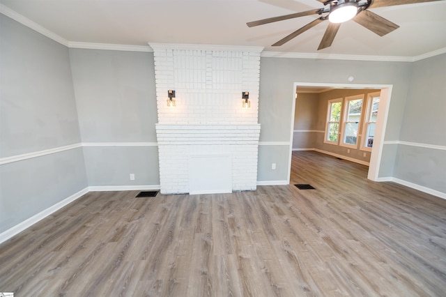 unfurnished living room with a fireplace, light hardwood / wood-style flooring, ornamental molding, and ceiling fan