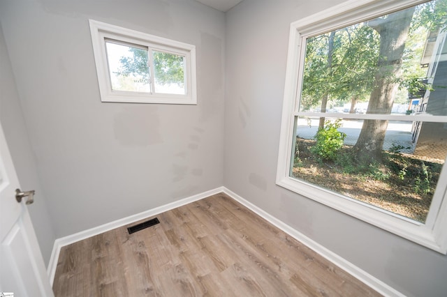 empty room with hardwood / wood-style flooring