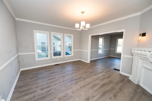 interior space featuring an inviting chandelier, ornamental molding, and dark hardwood / wood-style floors