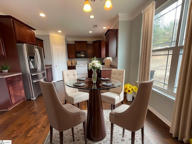 312 Engelmann Ln, Simpsonville, SC 29680 - dining room featuring dark wood-type flooring, crown molding, and an inviting chandelier
