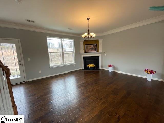 312 Engelmann Ln, Simpsonville, SC 29680 - unfurnished living room with dark hardwood / wood-style flooring, a notable chandelier, and ornamental molding