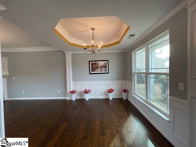 312 Engelmann Ln, Simpsonville, SC 29680 - interior space featuring a raised ceiling, crown molding, a chandelier, and dark hardwood / wood-style flooring