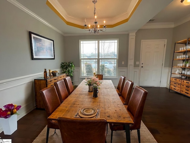 312 Engelmann Ln, Simpsonville, SC 29680 - dining space with dark wood-type flooring, a notable chandelier, a tray ceiling, ornamental molding, and ornate columns