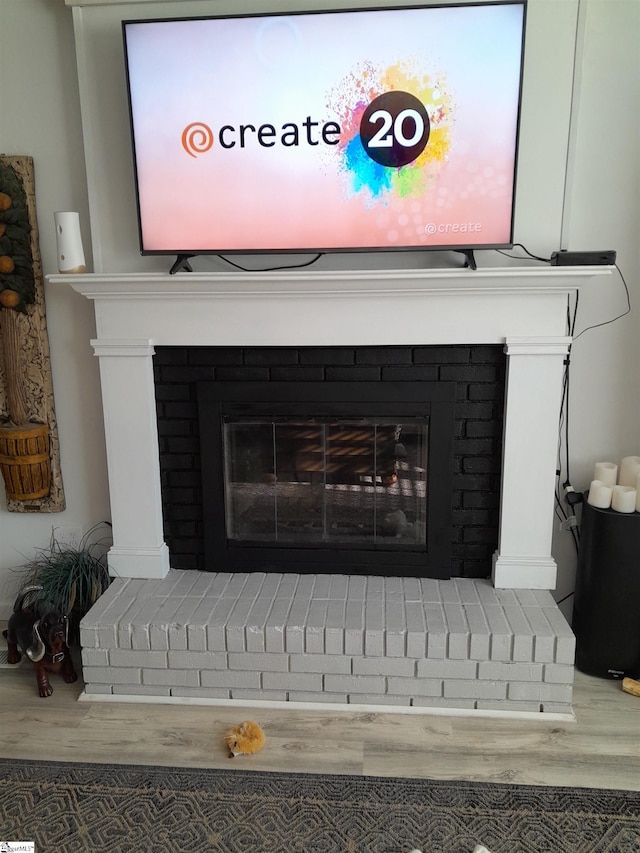 room details with a fireplace and wood-type flooring