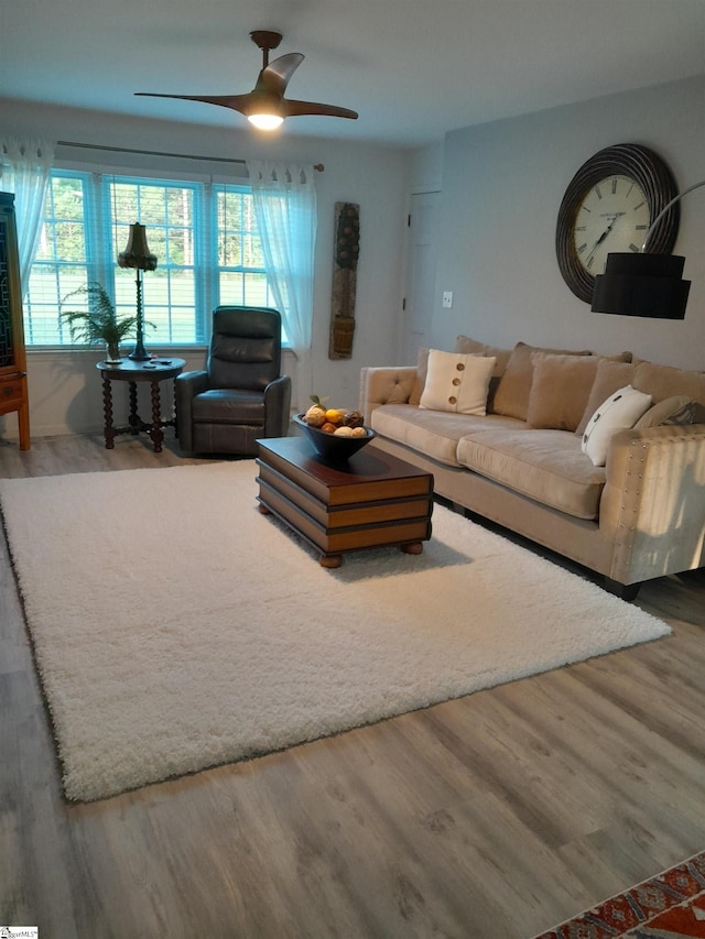 living room with wood-type flooring, ceiling fan, and plenty of natural light