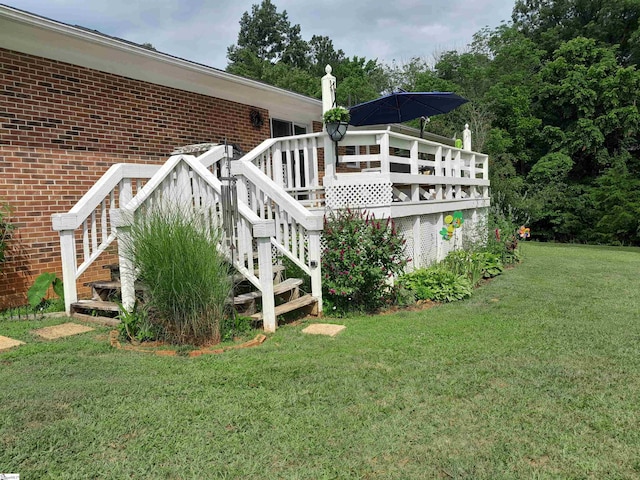 view of home's exterior featuring a lawn and a deck