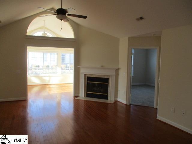 unfurnished living room featuring ceiling fan, high vaulted ceiling, and dark hardwood / wood-style flooring