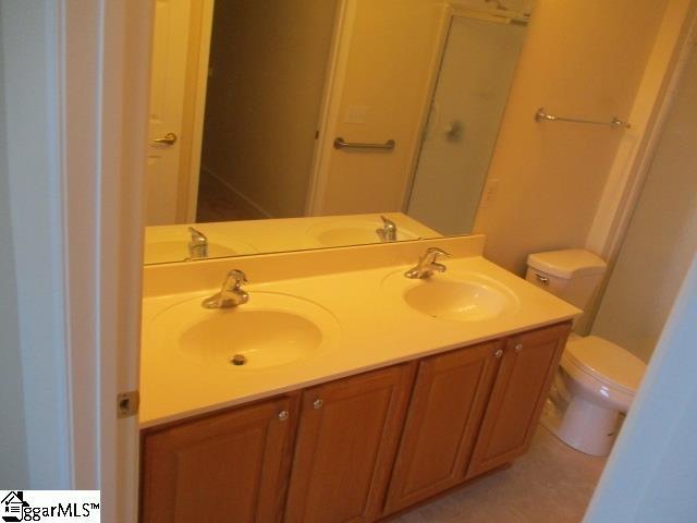 bathroom with vanity, tile patterned floors, and toilet