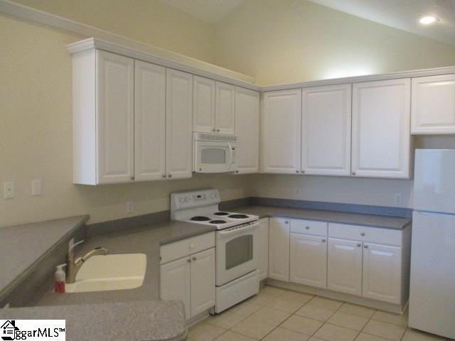 kitchen featuring white cabinetry, white appliances, and sink