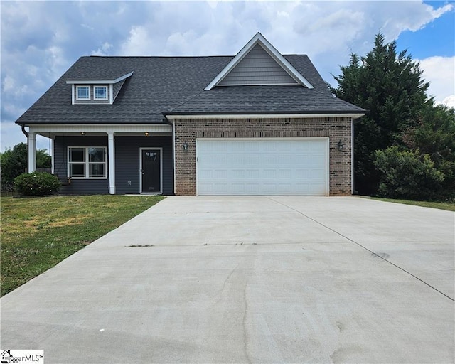 view of front of property with a garage and a front lawn