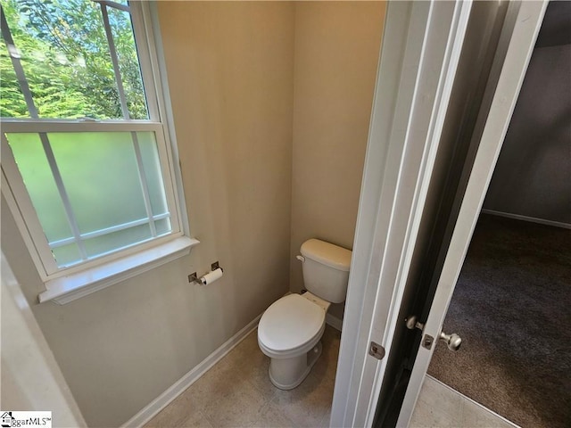 bathroom featuring tile patterned flooring and toilet