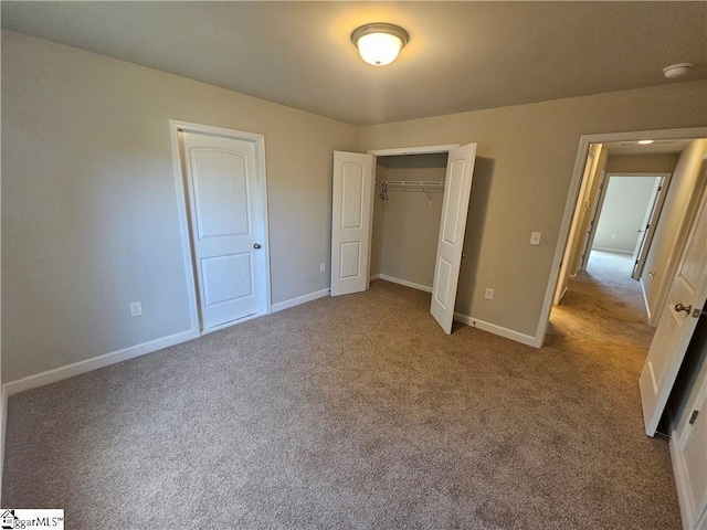 unfurnished bedroom with light colored carpet and a closet