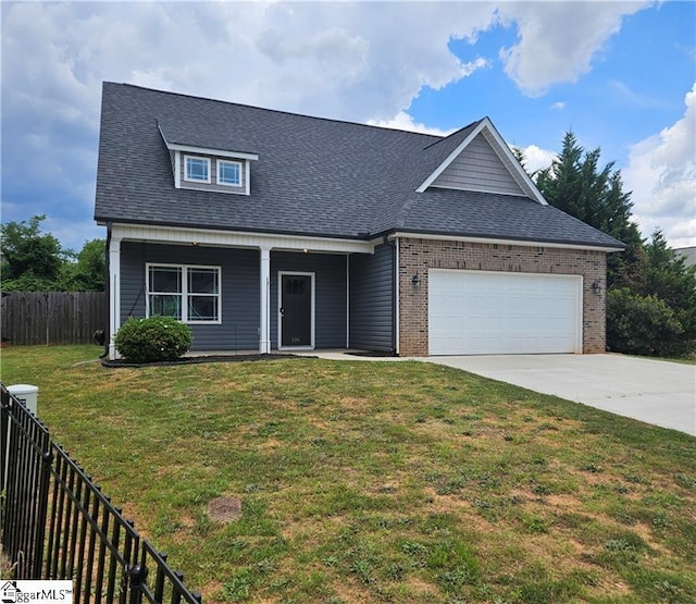 view of front of house with a garage and a front yard