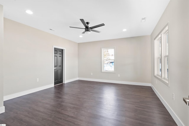 spare room featuring dark hardwood / wood-style floors and ceiling fan