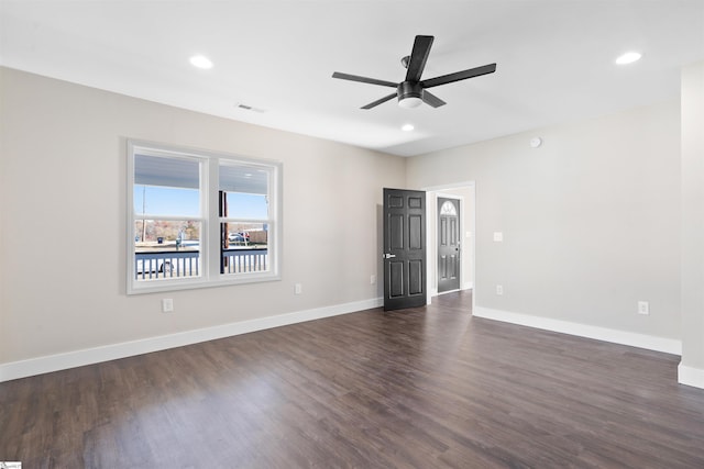 spare room with ceiling fan and dark hardwood / wood-style flooring