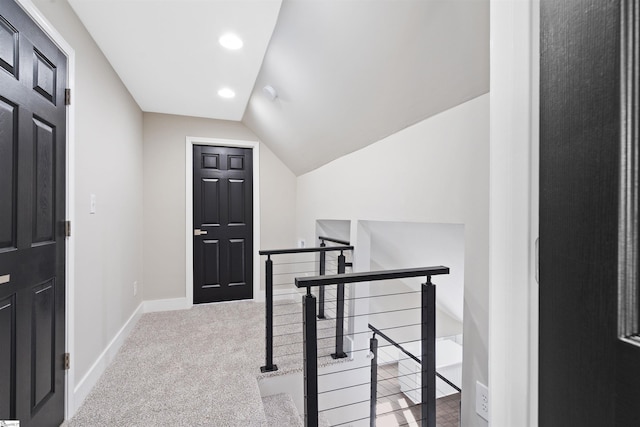 carpeted office featuring vaulted ceiling