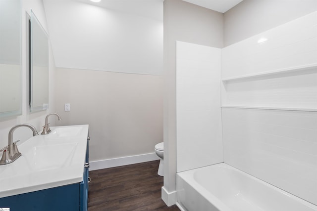 full bathroom featuring washtub / shower combination, vanity, toilet, and hardwood / wood-style floors