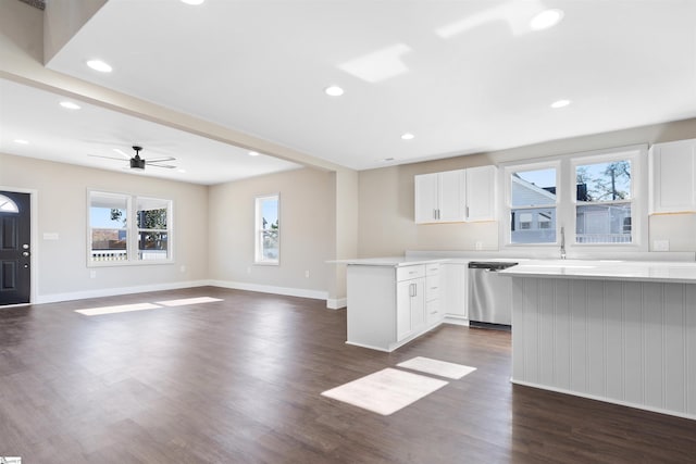 kitchen with white cabinetry, dishwasher, dark hardwood / wood-style flooring, ceiling fan, and kitchen peninsula