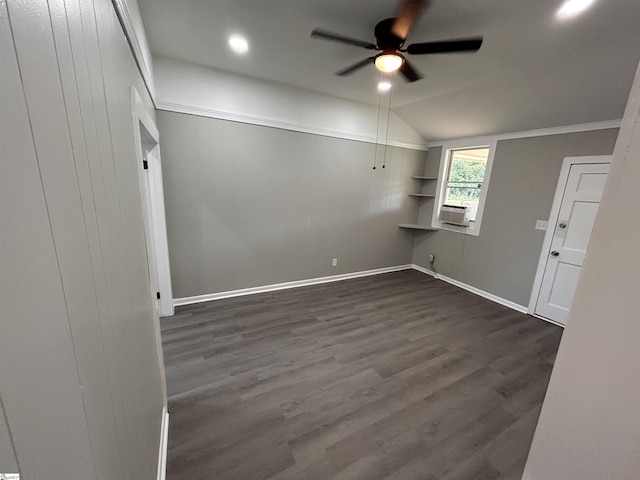 spare room featuring lofted ceiling, dark wood-type flooring, cooling unit, and ceiling fan