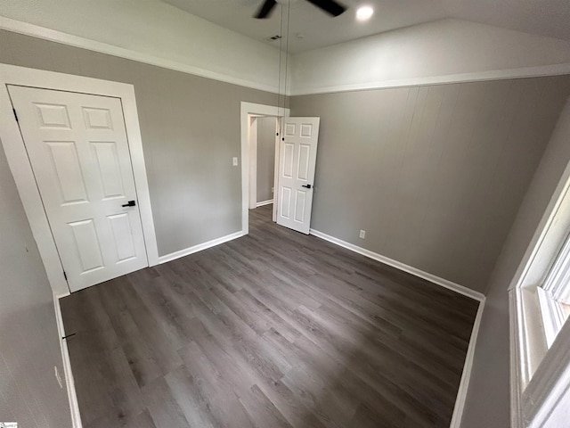 unfurnished bedroom featuring dark wood-type flooring, ceiling fan, and lofted ceiling