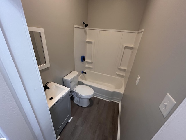 full bathroom featuring hardwood / wood-style flooring, shower / bath combination, vanity, and toilet