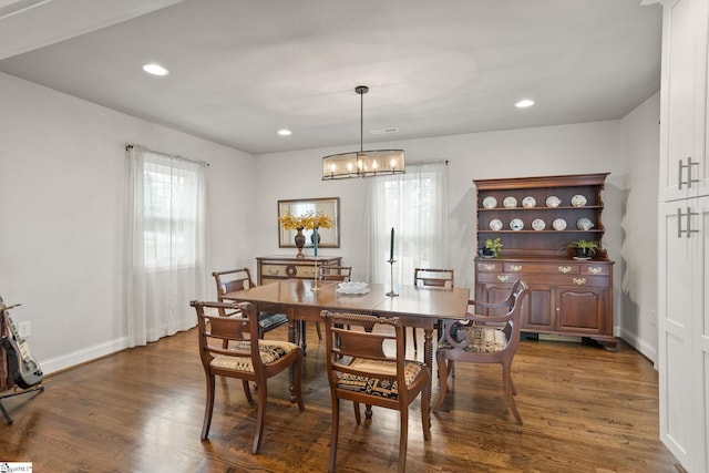 dining room featuring an inviting chandelier and dark hardwood / wood-style flooring