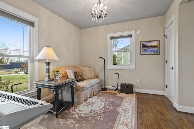 sitting room featuring an inviting chandelier and dark hardwood / wood-style flooring