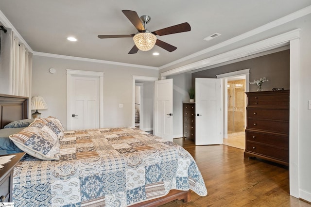 bedroom with crown molding, ceiling fan, connected bathroom, and dark hardwood / wood-style floors