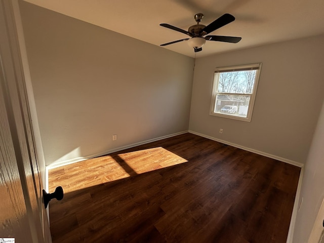 empty room with dark hardwood / wood-style floors and ceiling fan