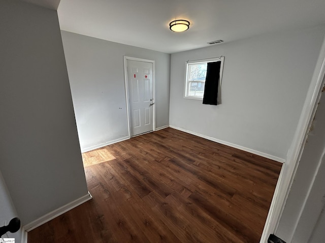 spare room featuring dark hardwood / wood-style flooring