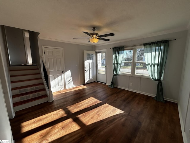 entrance foyer with crown molding, ceiling fan, dark hardwood / wood-style flooring, and a textured ceiling