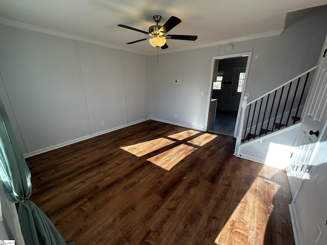 interior space featuring ceiling fan, ornamental molding, and dark hardwood / wood-style floors