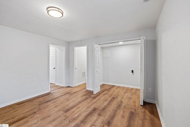 unfurnished bedroom with hardwood / wood-style floors and a closet