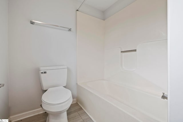 bathroom with hardwood / wood-style flooring and toilet