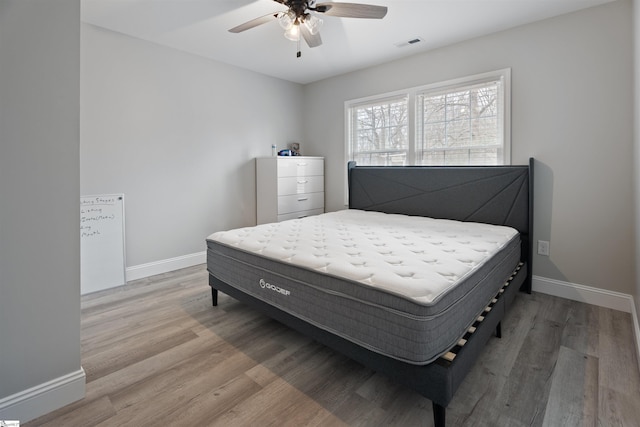 bedroom featuring hardwood / wood-style flooring and ceiling fan